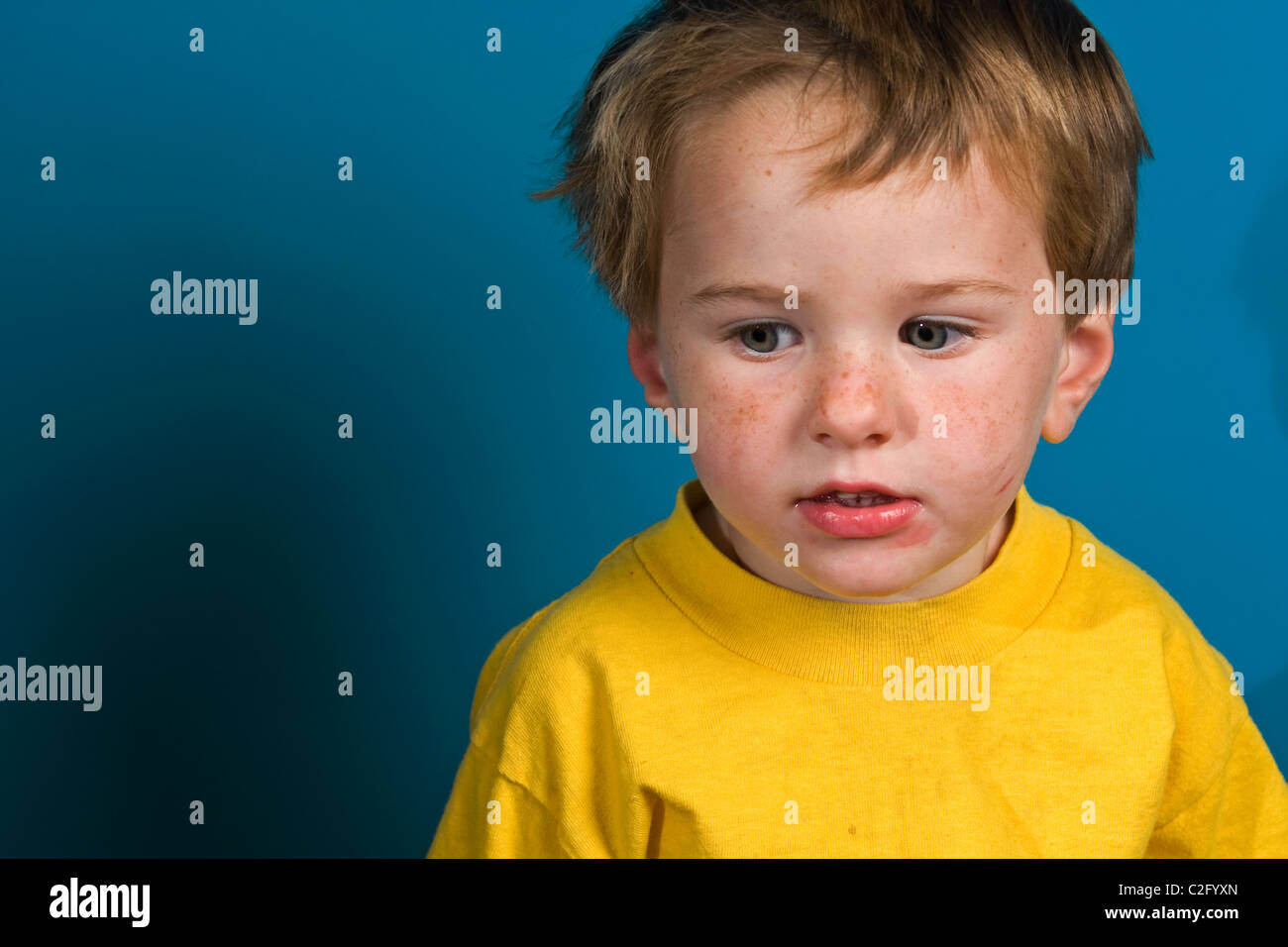 A 2 year old boy deep in thought. Stock Photo