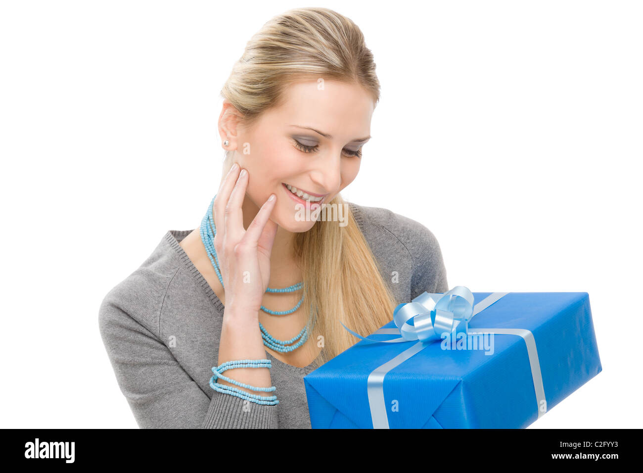 Young happy woman hold blue present with ribbon Stock Photo - Alamy
