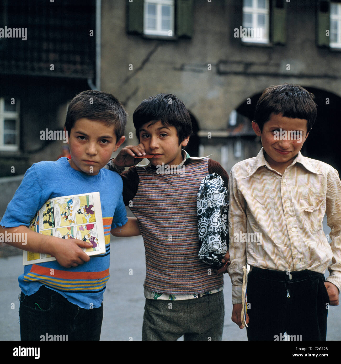 Seventies, people, children of guest-workers, Turks, three boys pose in front of the mining settlement Schuengelberg, aged 9 to 12 years, one boy with present under his arm, one boy with comic book in the hand, D-Gelsenkirchen, D-Gelsenkirchen-Buer, Ruhr Stock Photo