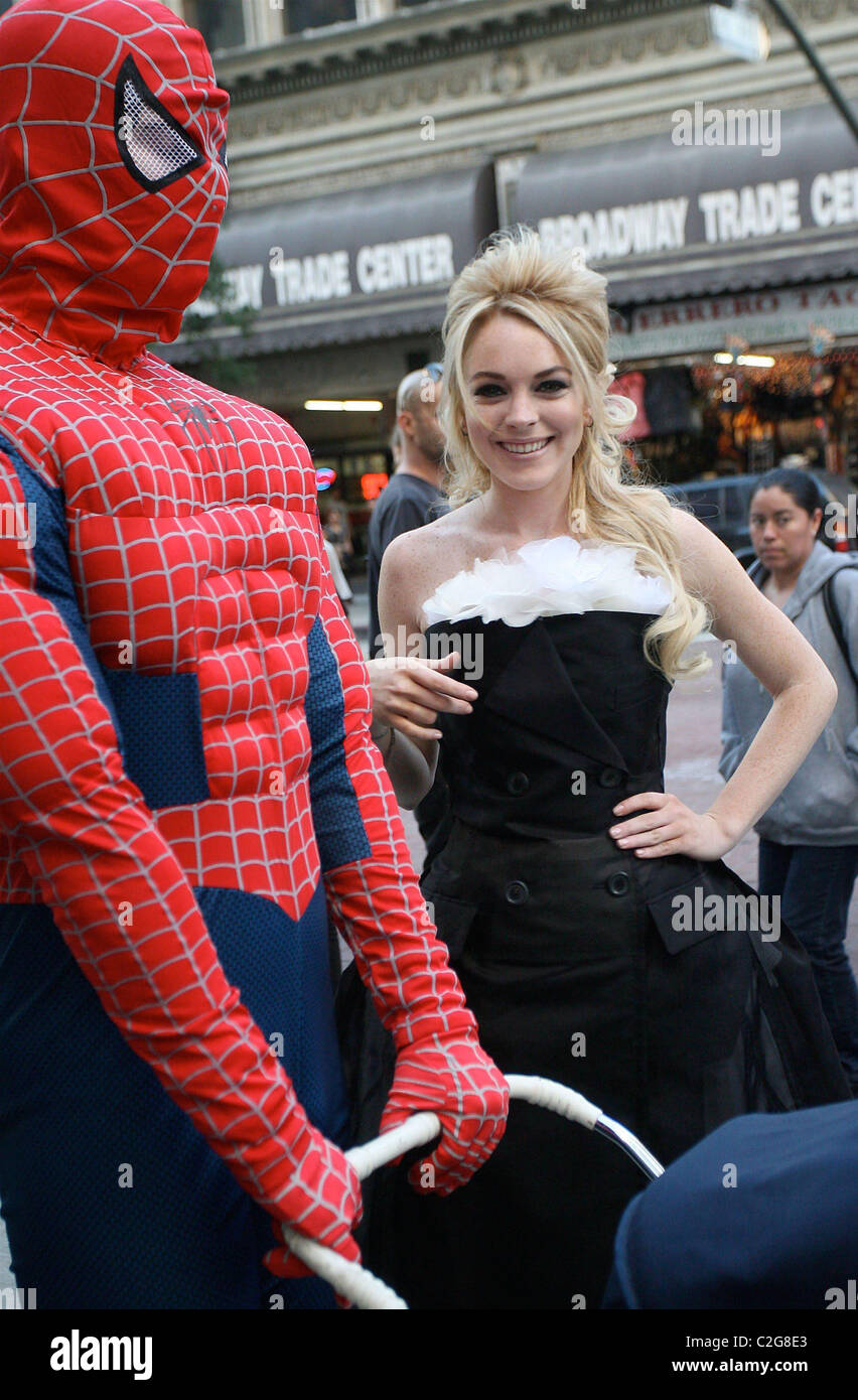 Lindsay Lohan wearing a black sixties style dress with SpiderMan LOHAN