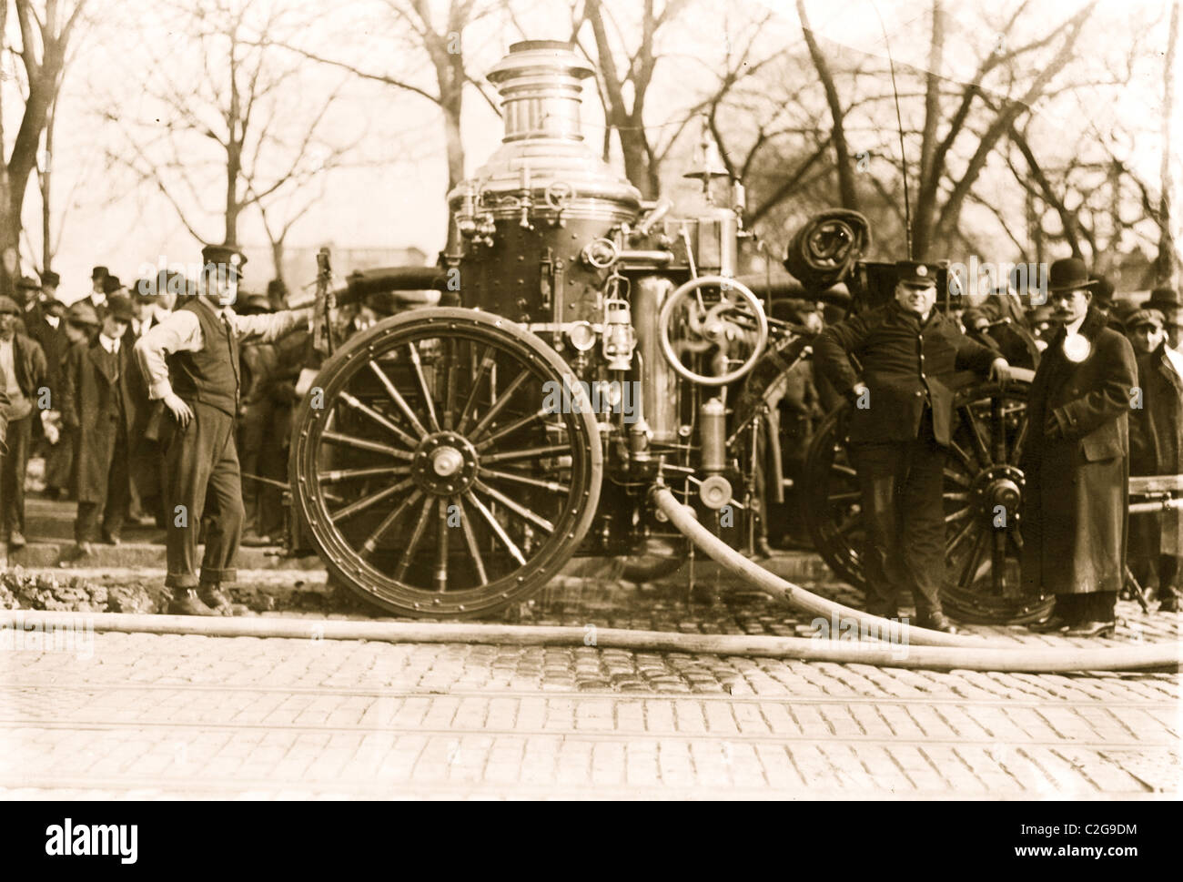 Two firemen with fire engine Stock Photo - Alamy