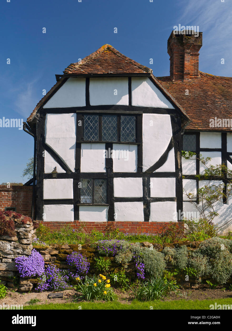 Historic traditional half timbered 'chocolate box' cottage with spring colour Send Surrey UK Stock Photo
