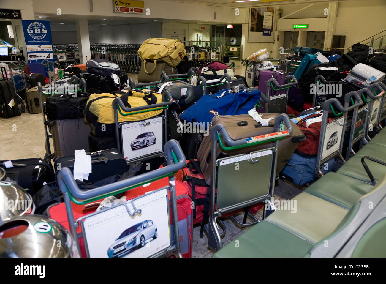 Backlog / back log / backlogged / delayed / piled up / stack / stacked luggage at London Heathrow LHR International airport. UK. Stock Photo