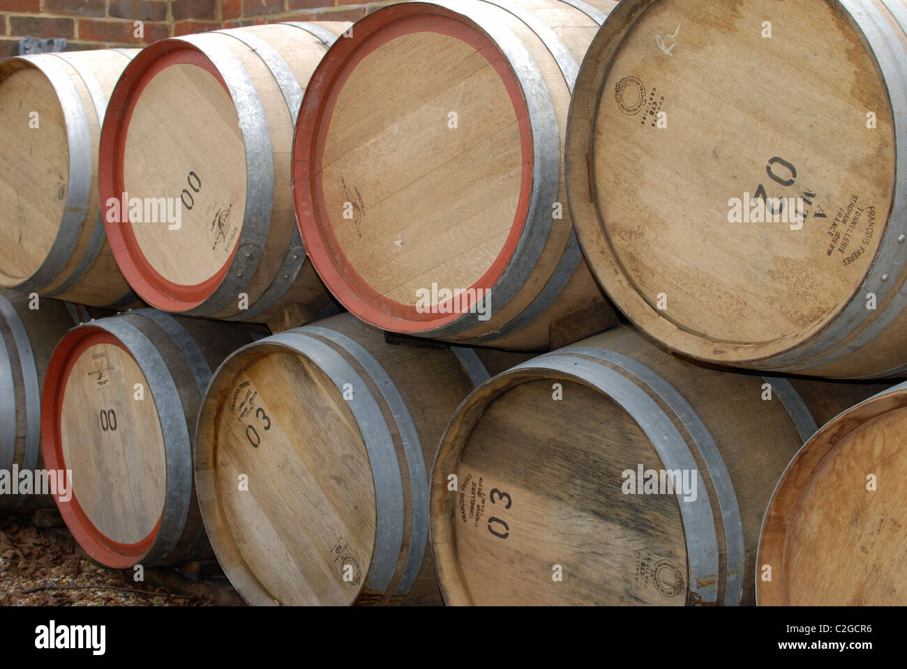 Stack of oak barrels used for wine. Outside vineyard in Surrey. England