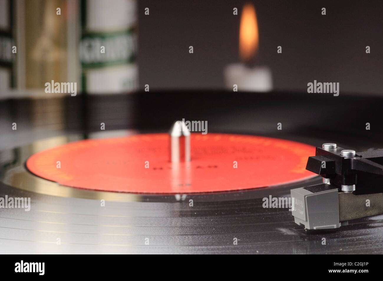 Old record player with LP and a beer can and a candle in the background Stock Photo