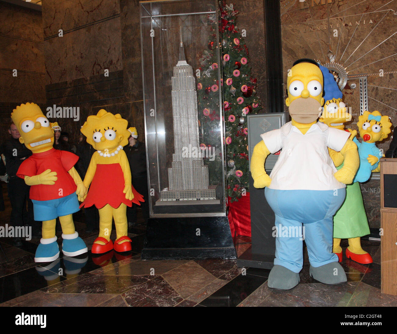 Bart Simpson, Lisa Simpson, Homer Simpson, Marge Simpson and Maggie Simpson  The Simpsons cartoon characters light up the Empire Stock Photo - Alamy