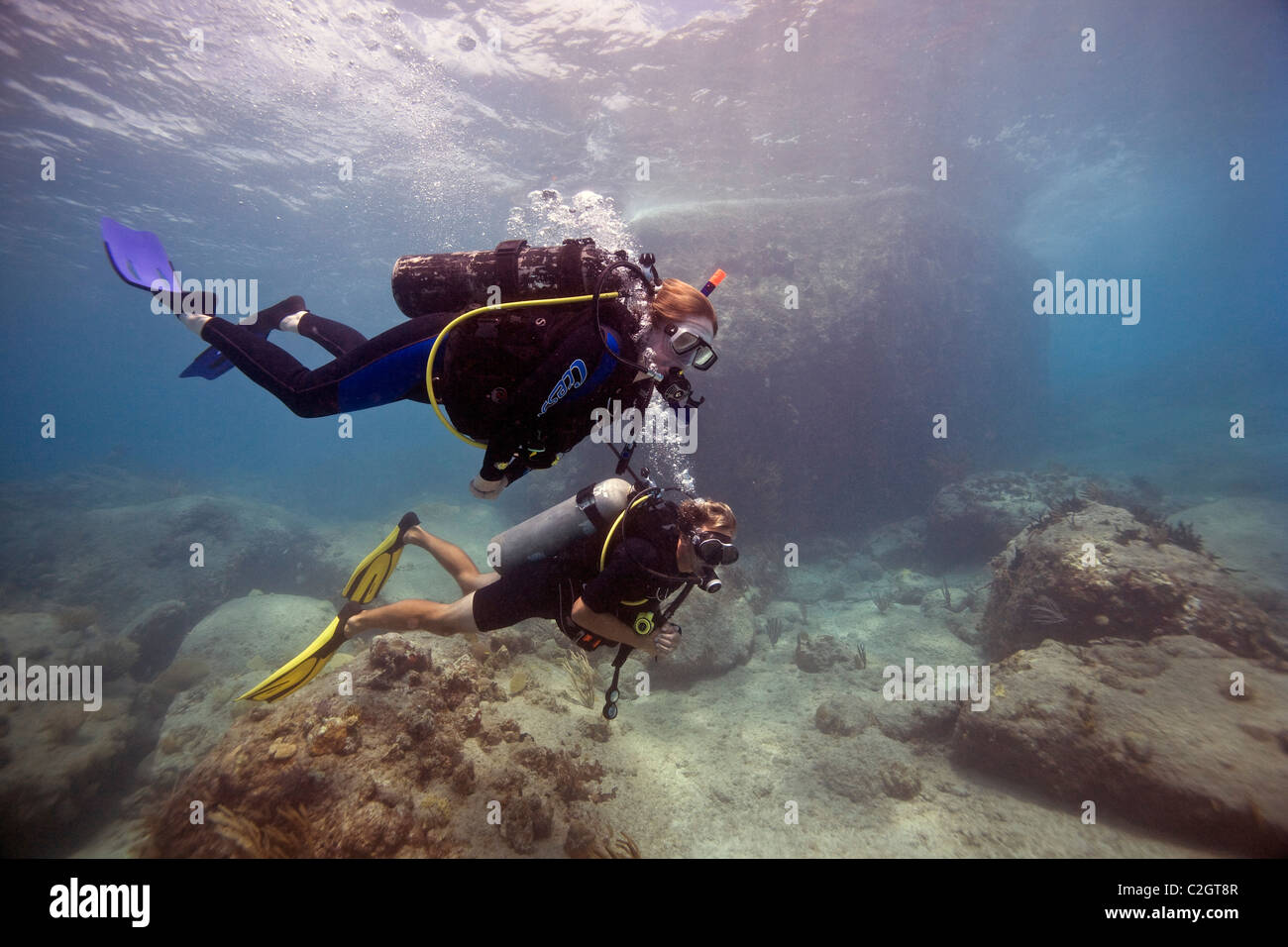 Two scuba divers diving at the 'Pillars of Hercules' near English Harbour, Antigua. Stock Photo