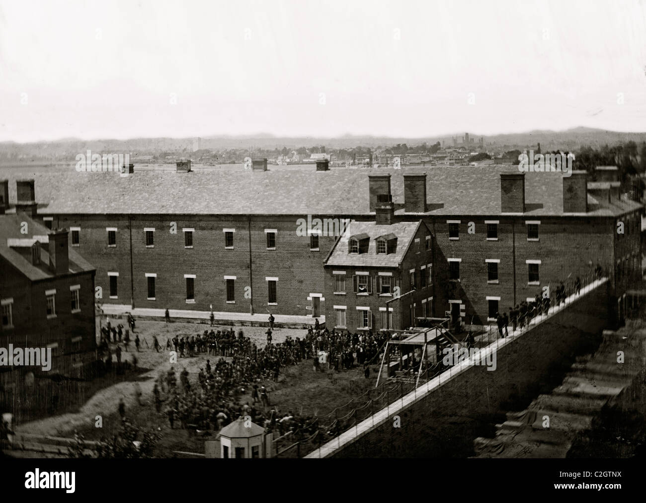 Washington, D.C. Execution of the conspirators: scaffold in use and crowd in the yard, seen from the roof of the Arsenal Stock Photo