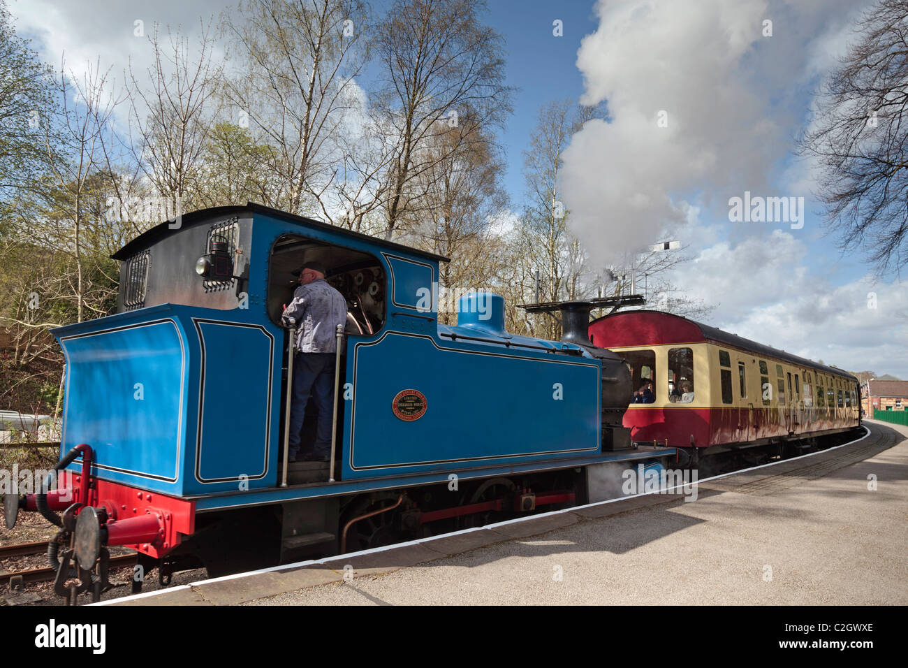 A steam train leaves Lakeside station on the Lakeside and Haverthwaite railway in the lake district on Windermere. Stock Photo