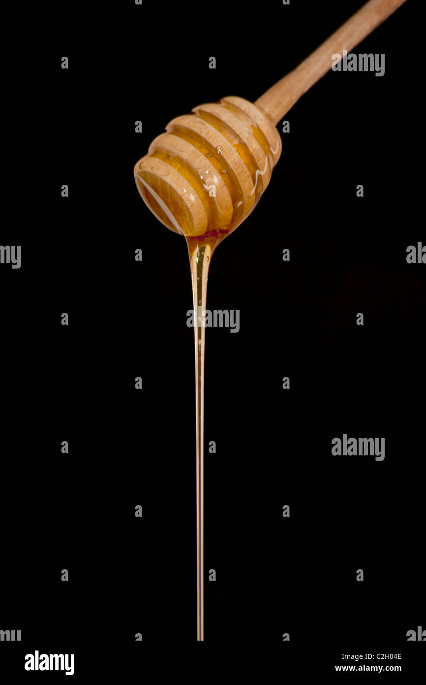 honey stick on the black background Stock Photo - Alamy