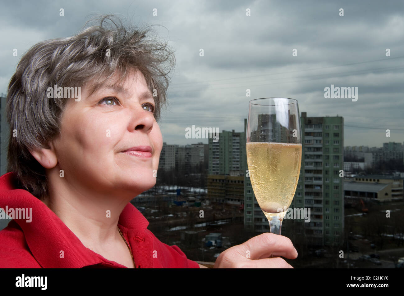 woman with champagne glass against the backdrop of the city Stock Photo