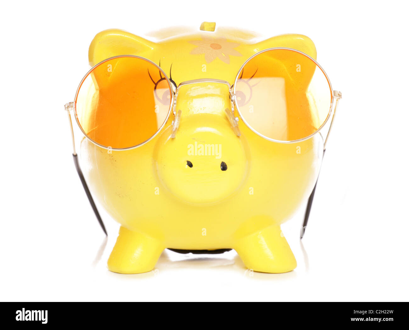 Yellow piggybank with sunglasses studio cutout Stock Photo