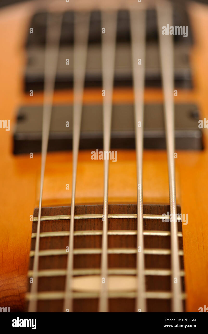 Close-up of a 5-string electric bass guitar, looking from the bottom of the neck towards the pickups Stock Photo