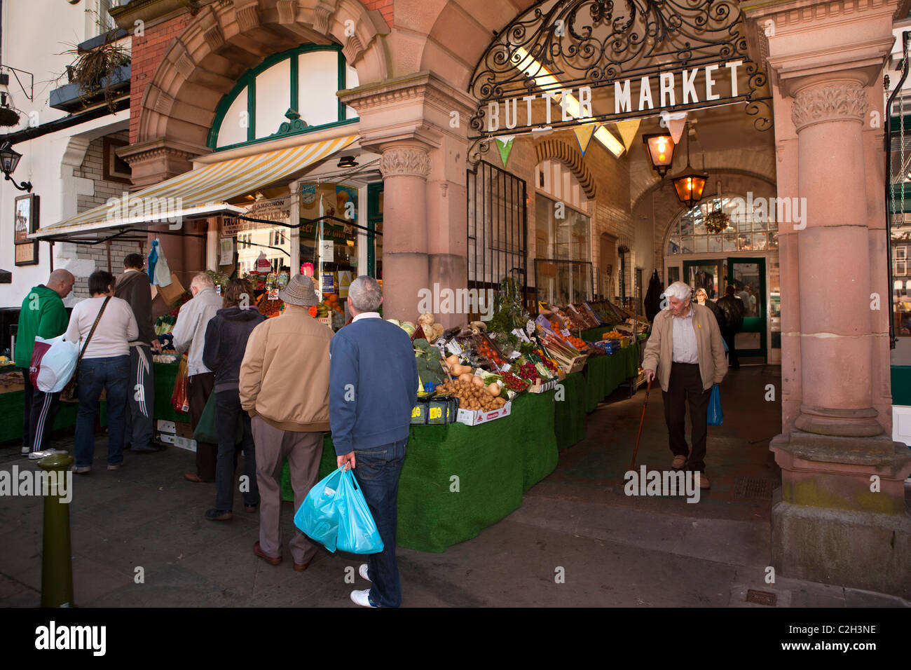 UK, England, Staffordshire, Leek, customers queueing at greengrocers shop at entrance to Butter Market, Stock Photo