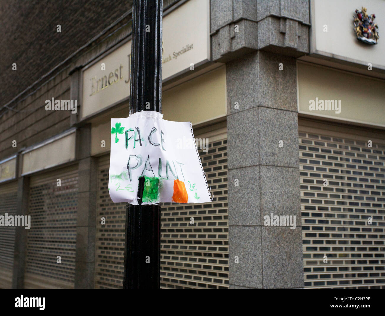 A sign for face painting shamrocks on a pole Stock Photo Alamy
