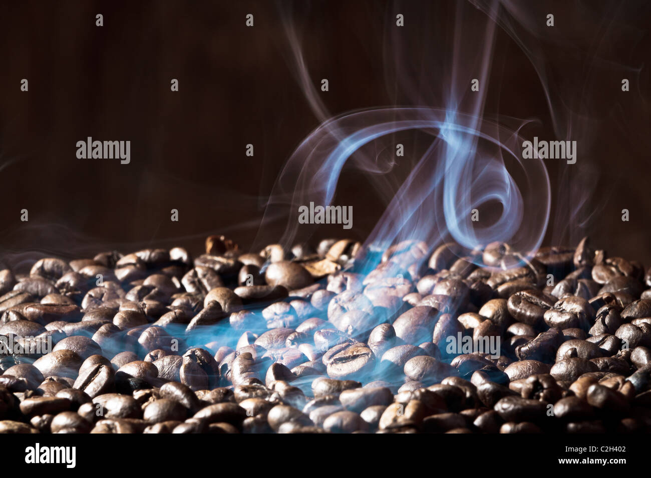 Fragrant roasted coffee beans on black background Stock Photo - Alamy