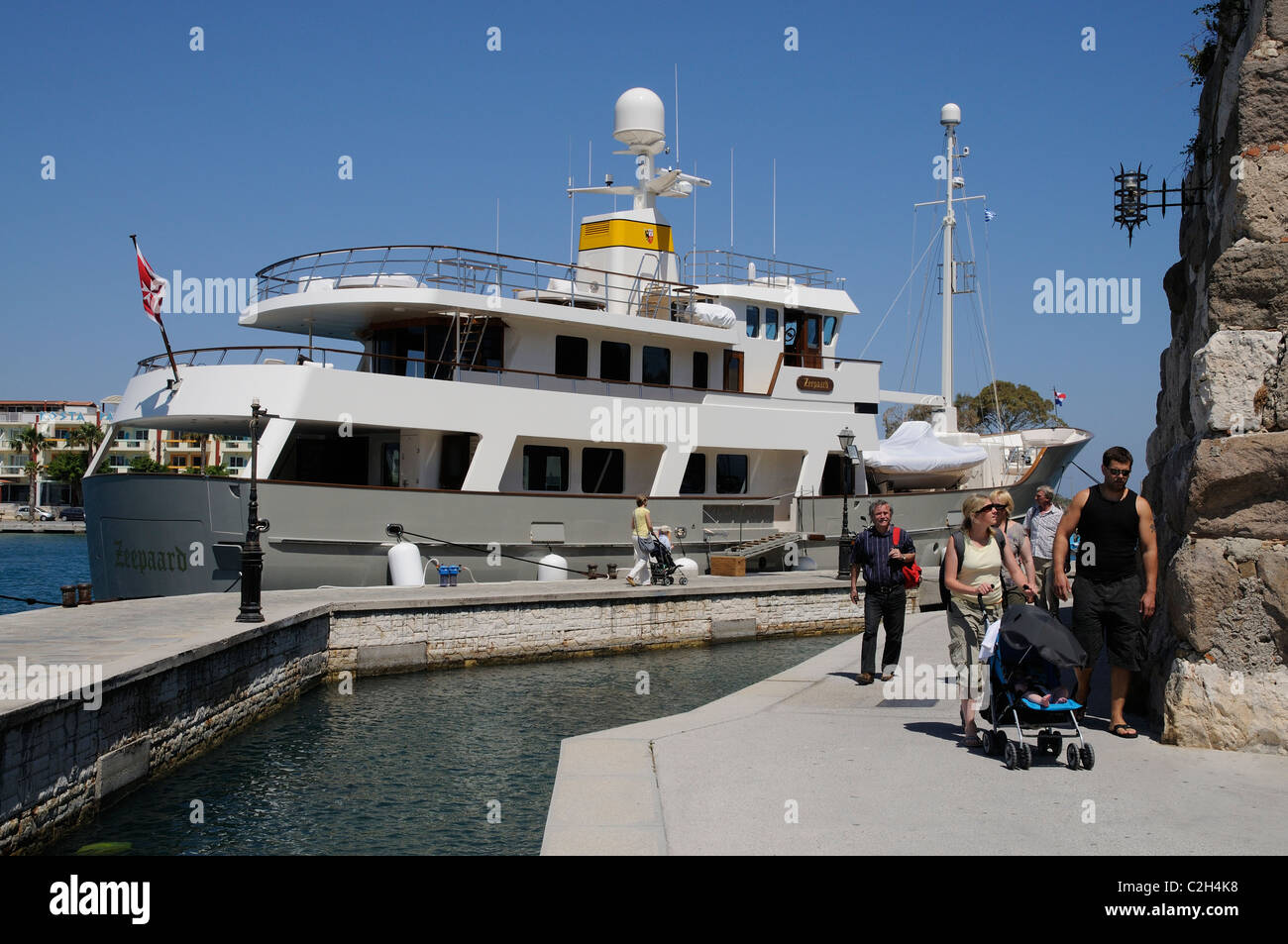 Visiting motor yacht flying the Maltese flag alongside on Kos Town harbour on Kos Island Greece Stock Photo
