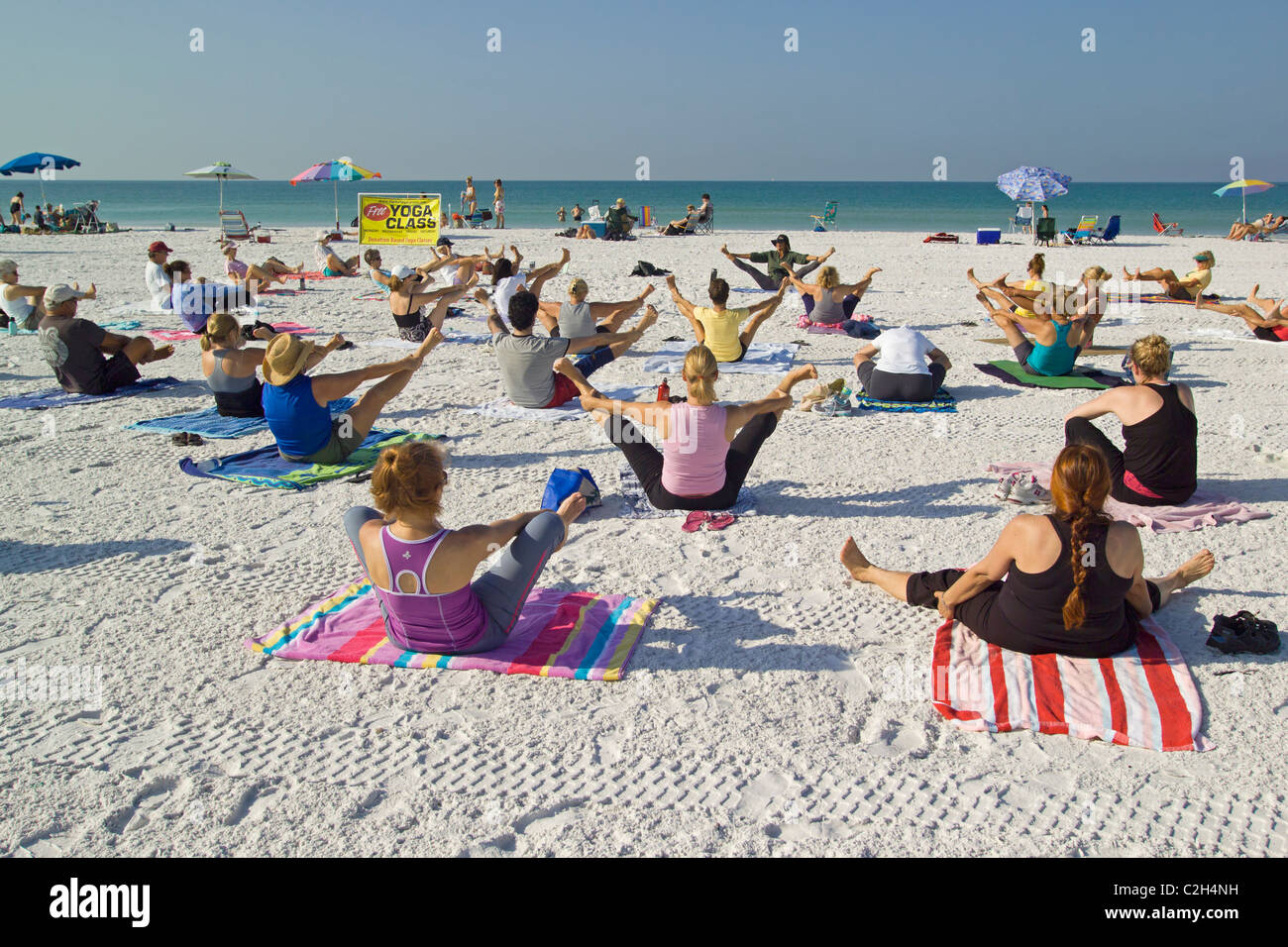 Yoga classes are held on the white sand beach of Siesta Key, a resort barrier island on the Gulf of Mexico at Sarasota, Florida. Stock Photo