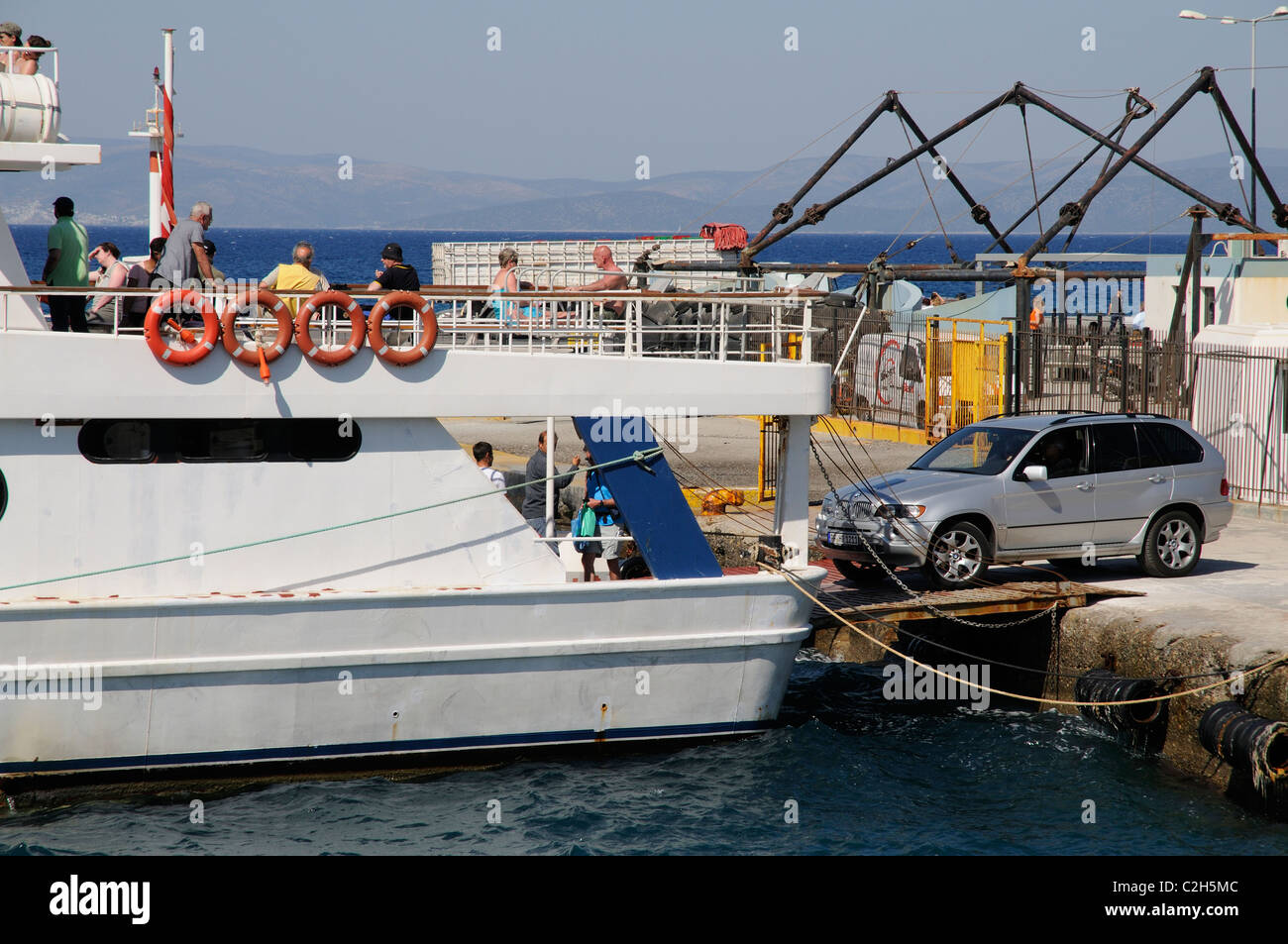 4x4 BMW car driving onto an inter island ferry in Kos Town harbour on Kos Island Greece Stock Photo