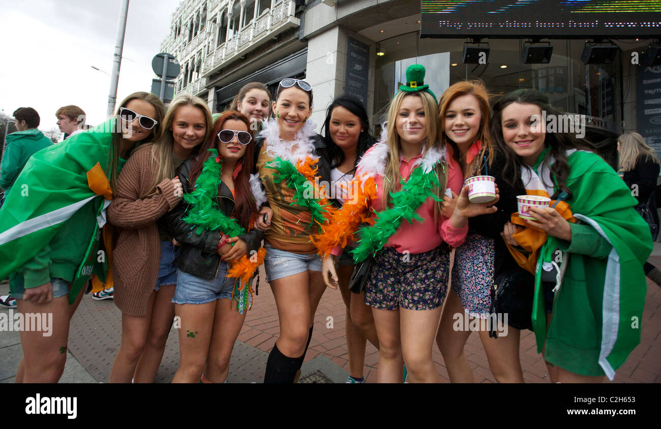 People in costume celebrating and attending the Saint Patricks Day parade in Dublin, Ireland. Dressed in the colors of Ireland. Stock Photo
