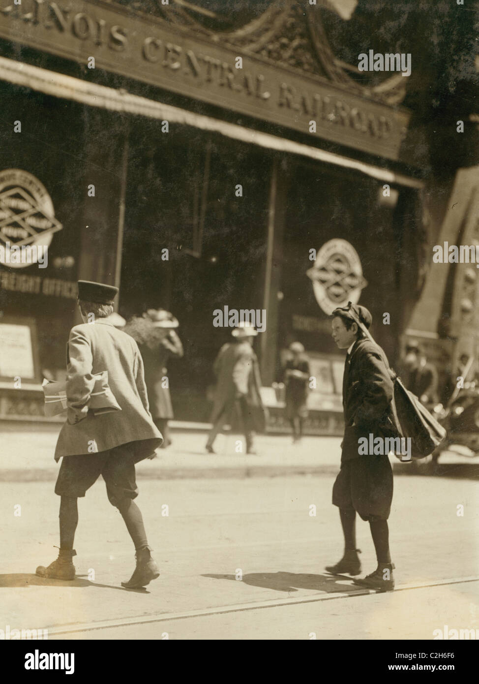 Bundle Boys carry packages as messengers outside of Illinois Central ...