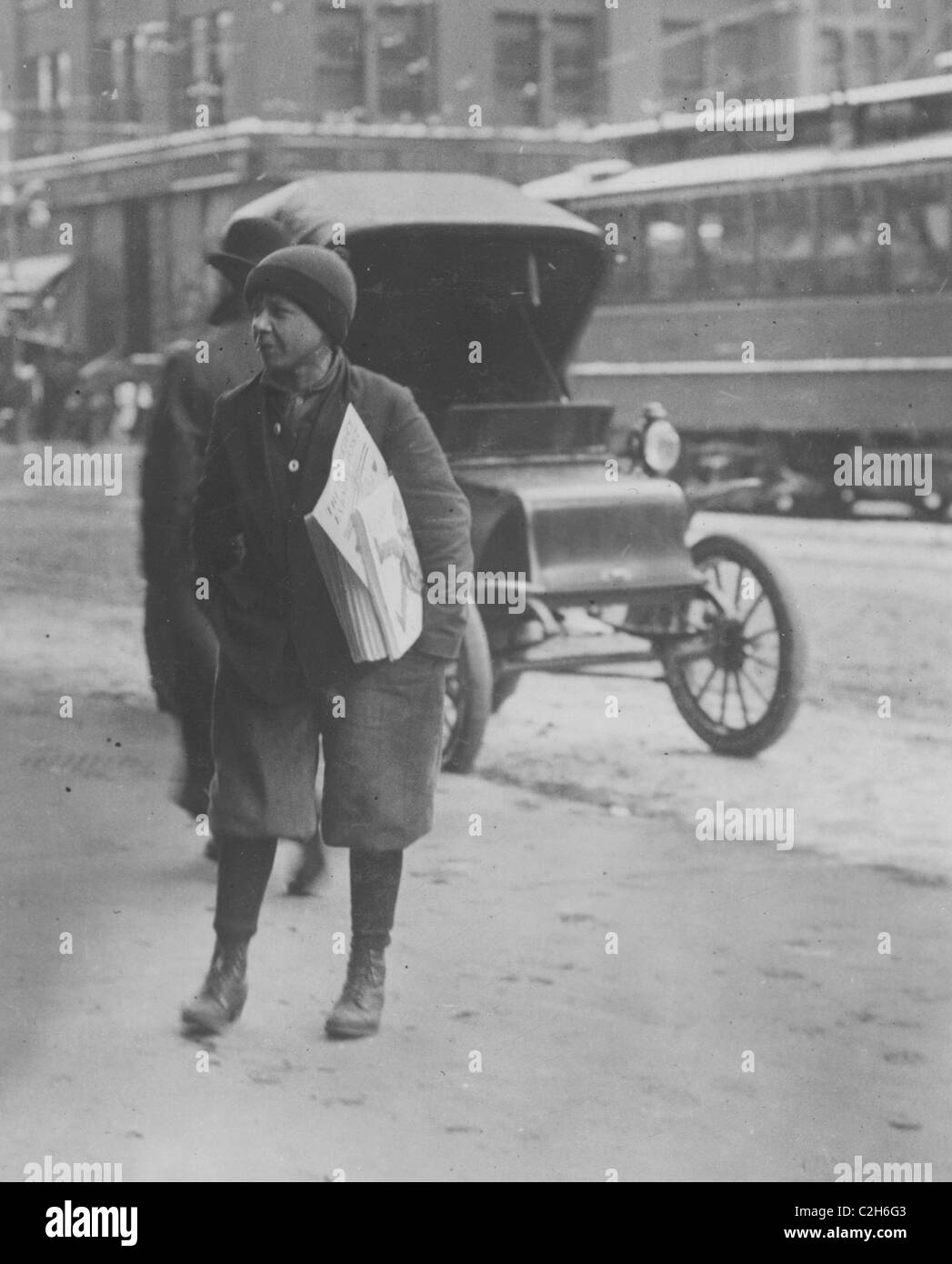 Selling Newspapers at 12:30 P.M., between school hours, on Main Street. Stock Photo