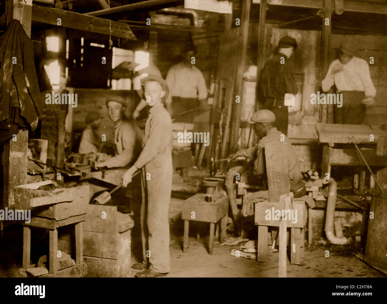 Cumberland Glass Works, Bridgeton, N.J. A young 'holding-mold boy' is seen, dimly, in middle distance to left of centre. Stock Photo