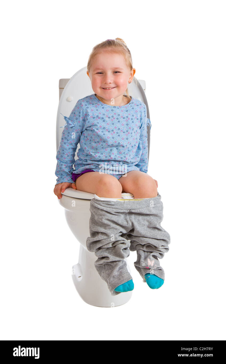 the little girl is sitting on toilet Stock Photo - Alamy