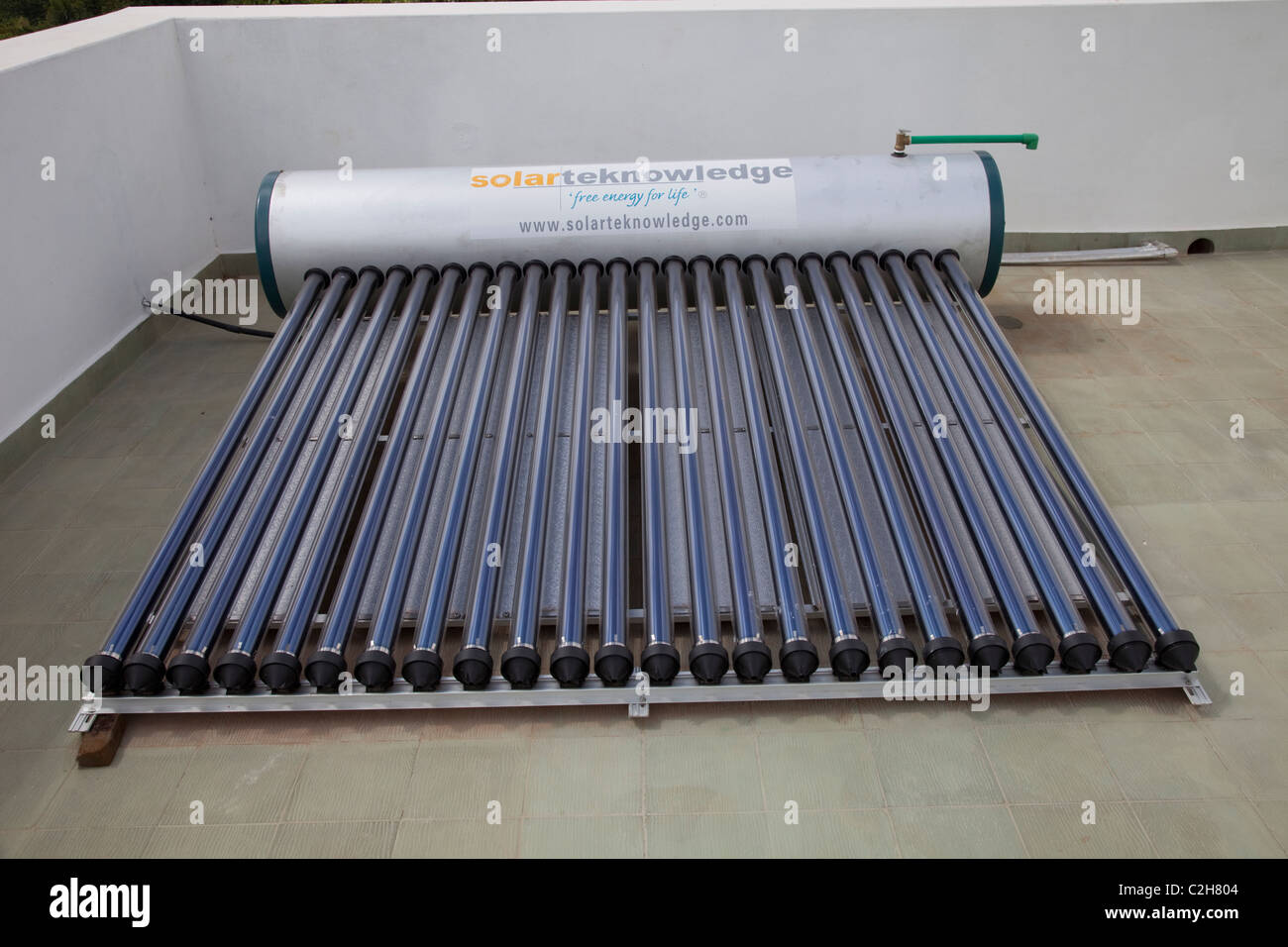 Solar thermal water heating system with tank and evacuated tubes on