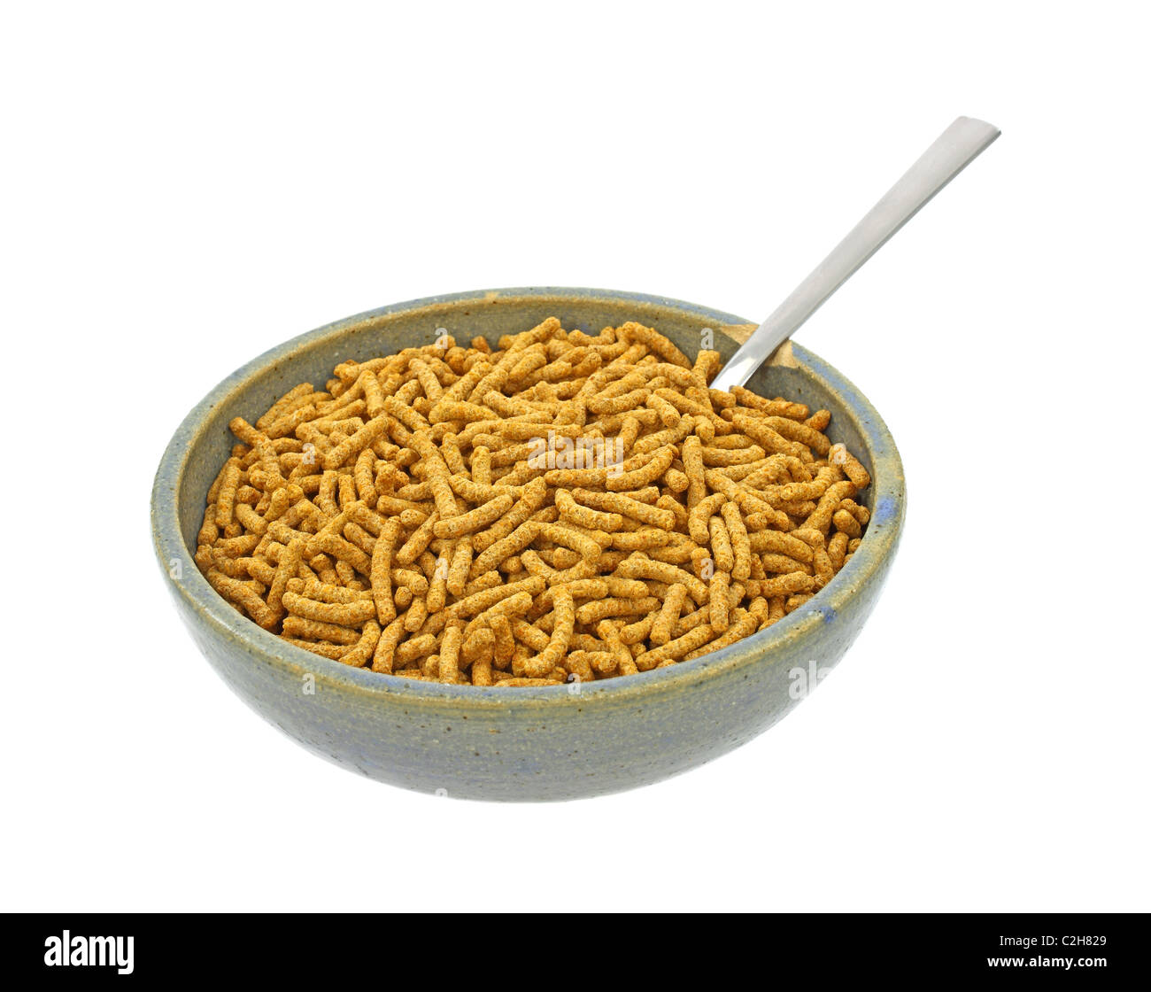 High fiber breakfast cereal in old bowl with spoon Stock Photo