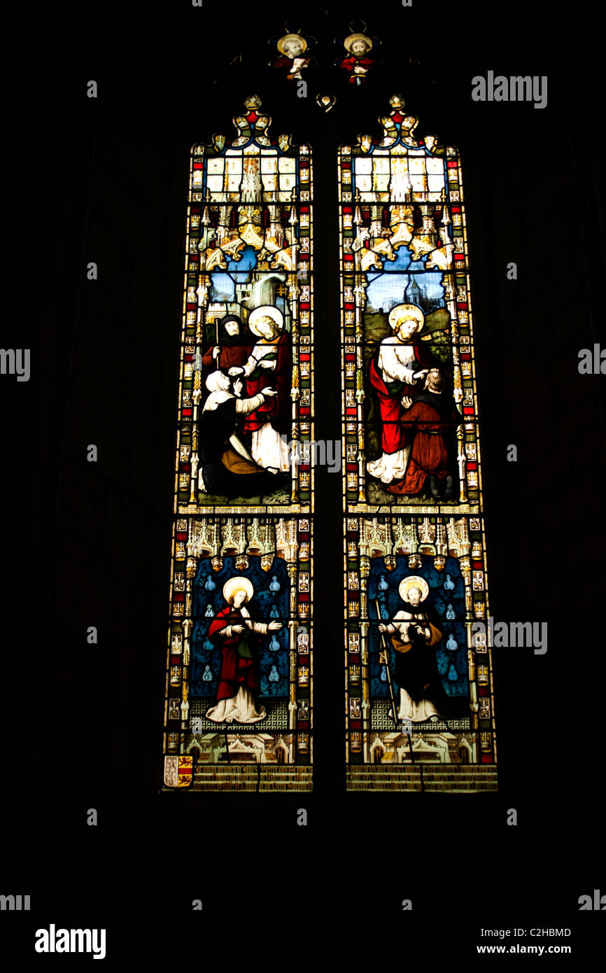 stain glass window church light colour dark surround religious picture story gospel saints god jesus almighty lead lined texture Stock Photo