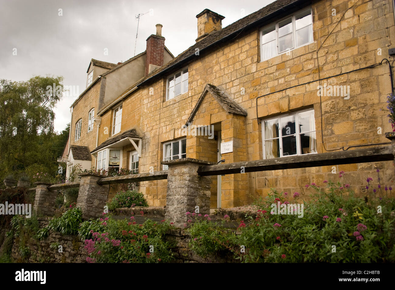 row terrace house stone cotswold structure building flat mortar blocks carved masonry hand crafted wall interlock home quaint Stock Photo