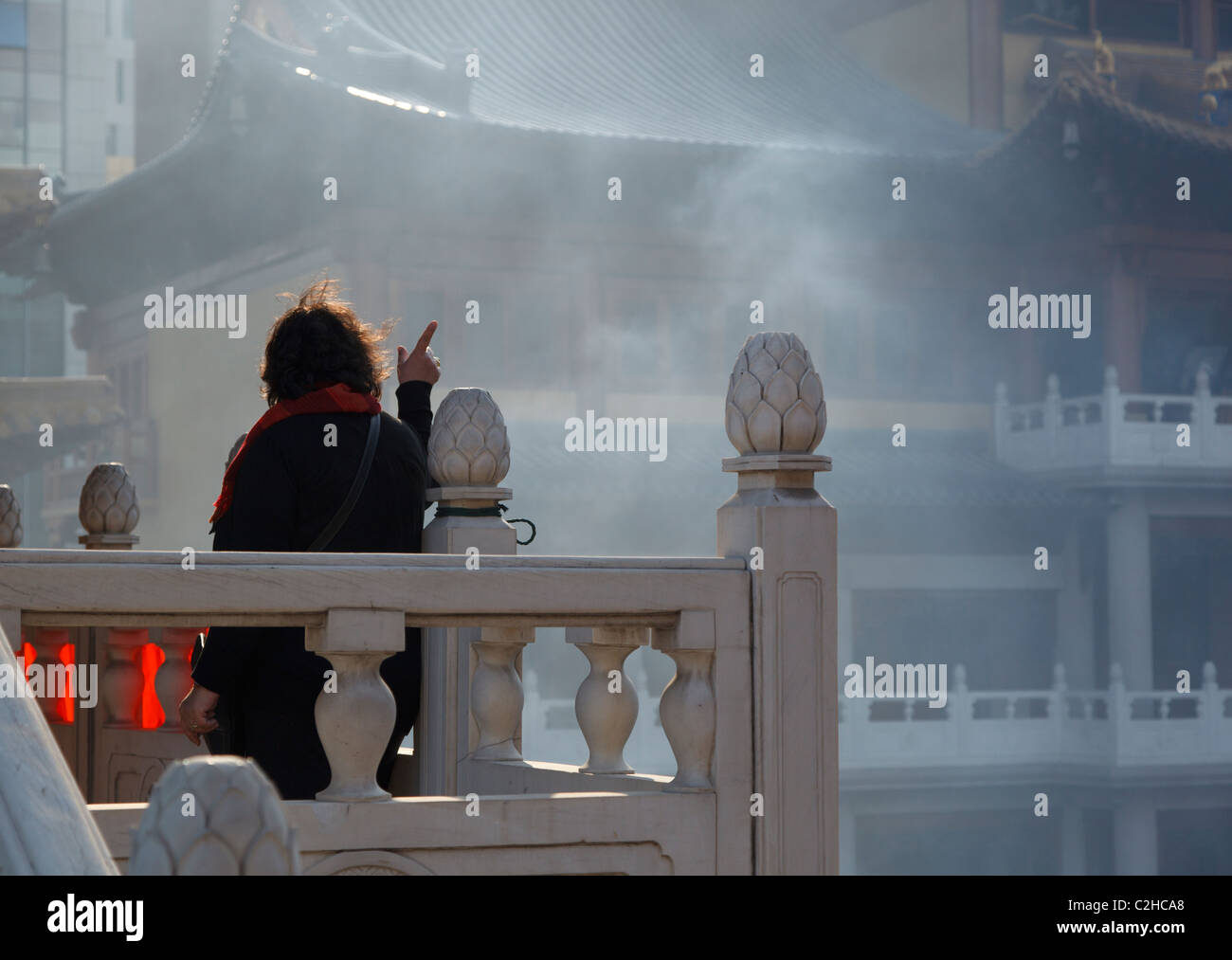 Woman pointing at Jingan Temple Stock Photo