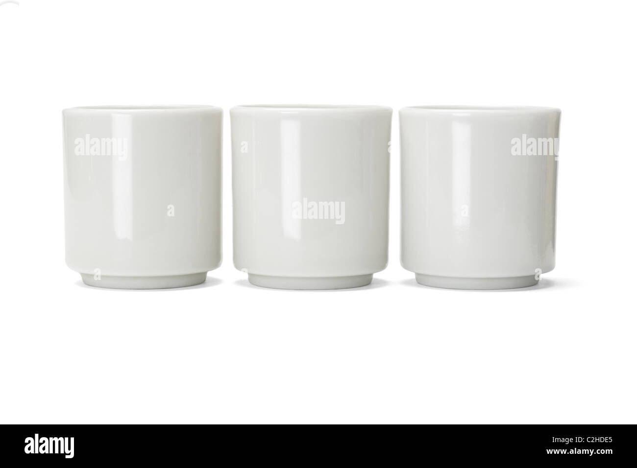 Three plain porcelain Chinese tea cups on white background Stock Photo