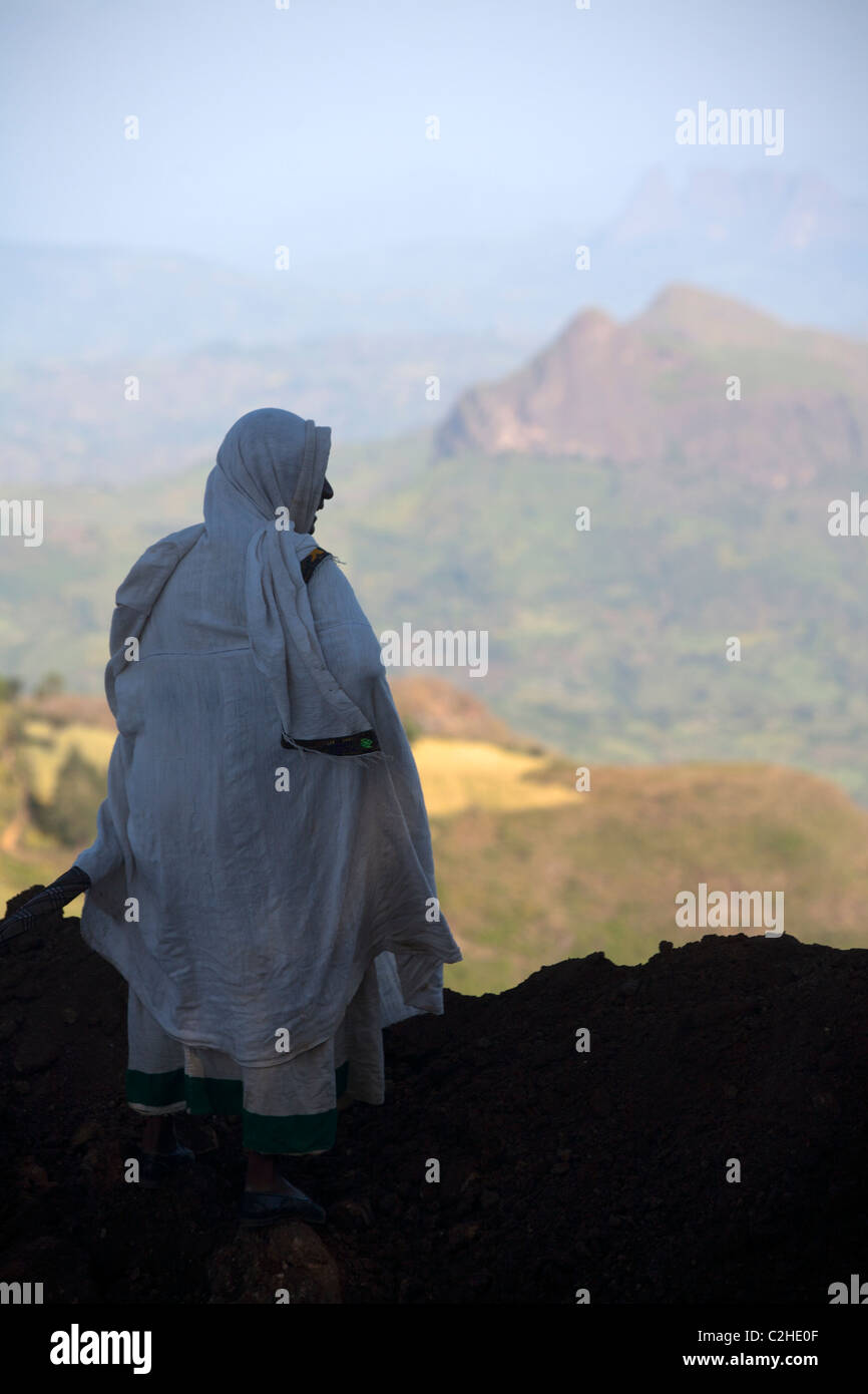 Villager looking out over the view from atop the Simien Mountains Stock Photo