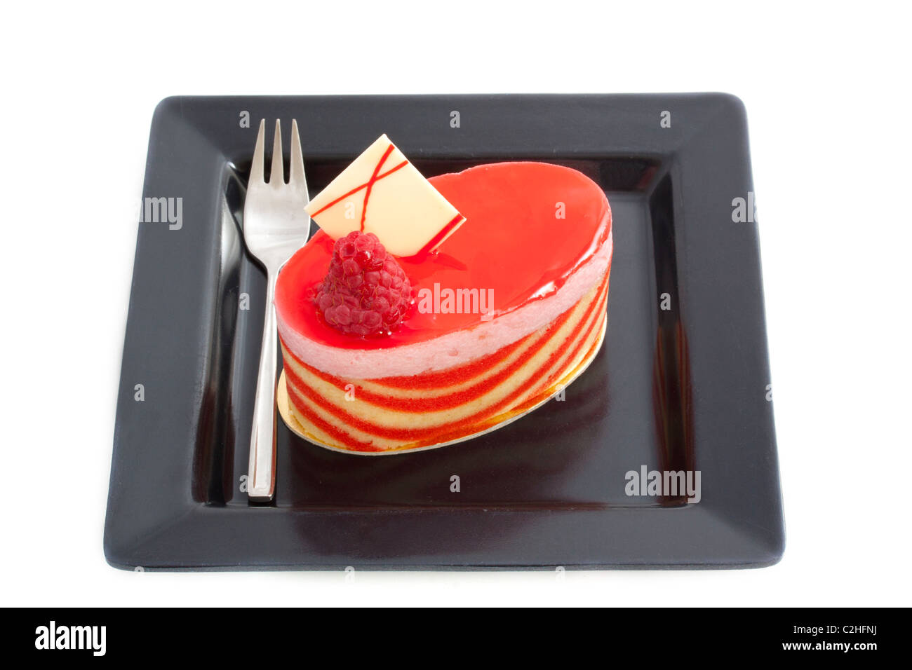 Piece of pie on a black plate isolated over white Stock Photo