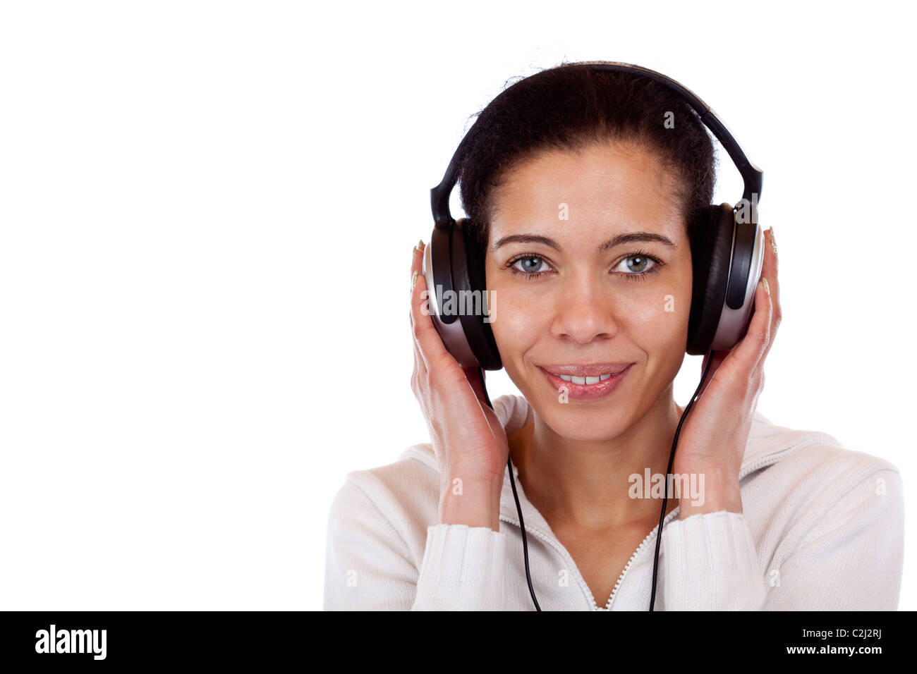 Beautiful, happy woman with headphones listens to mp3 music. Isolated on white background. Stock Photo