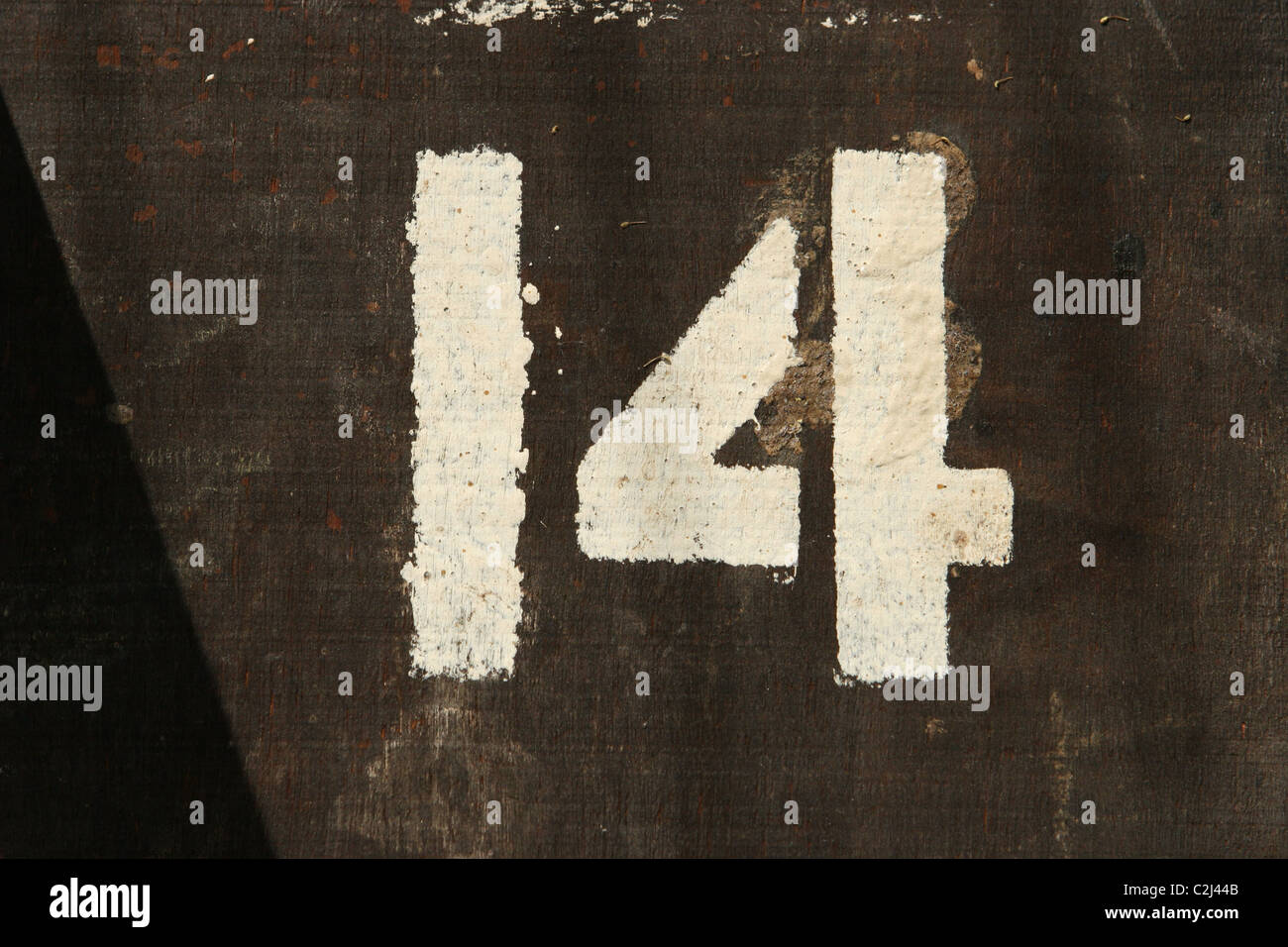 White Stencilled Painted Number 14 On Wood Stock Photo