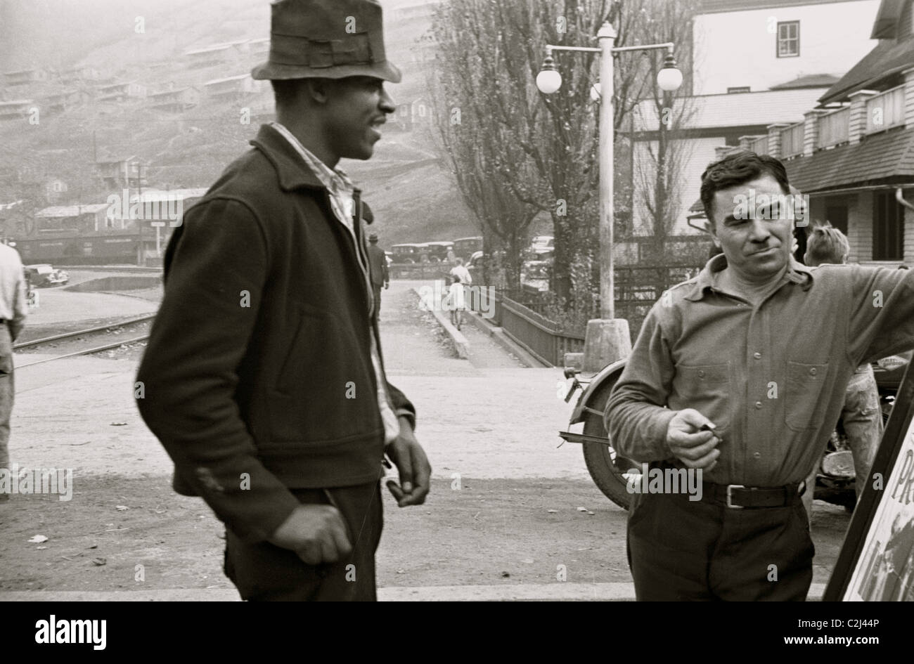 African American and a while man look at a sign Stock Photo