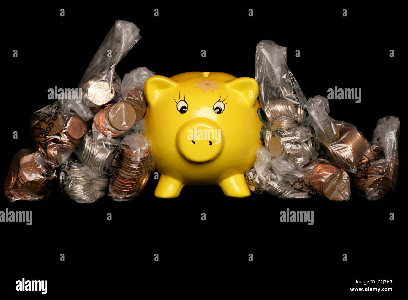 Yellow piggybank with sterling money studio cutout Stock Photo