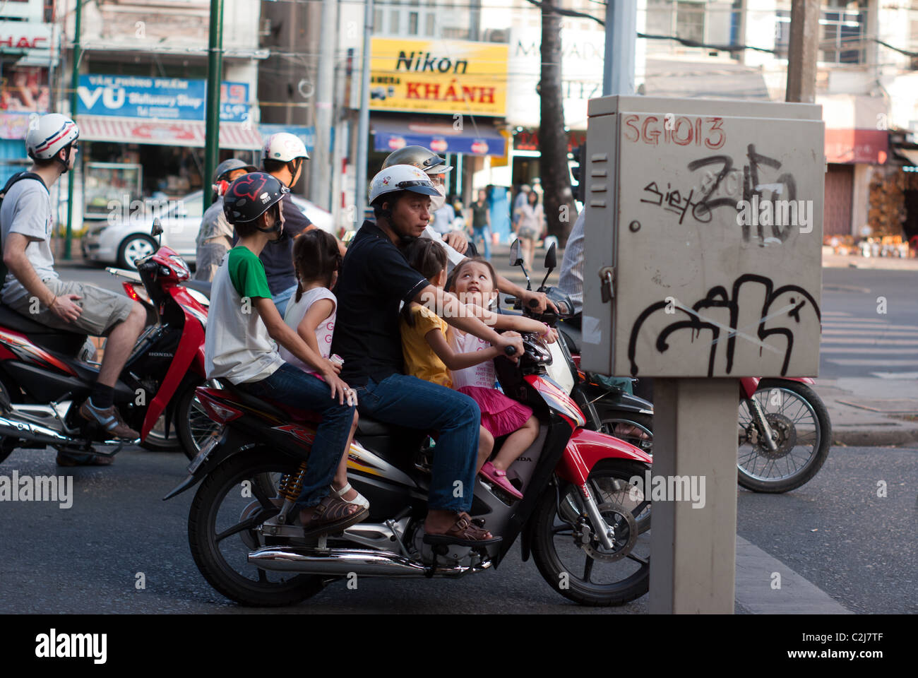 Family on motorbike in Saigon Vietnam Stock Photo