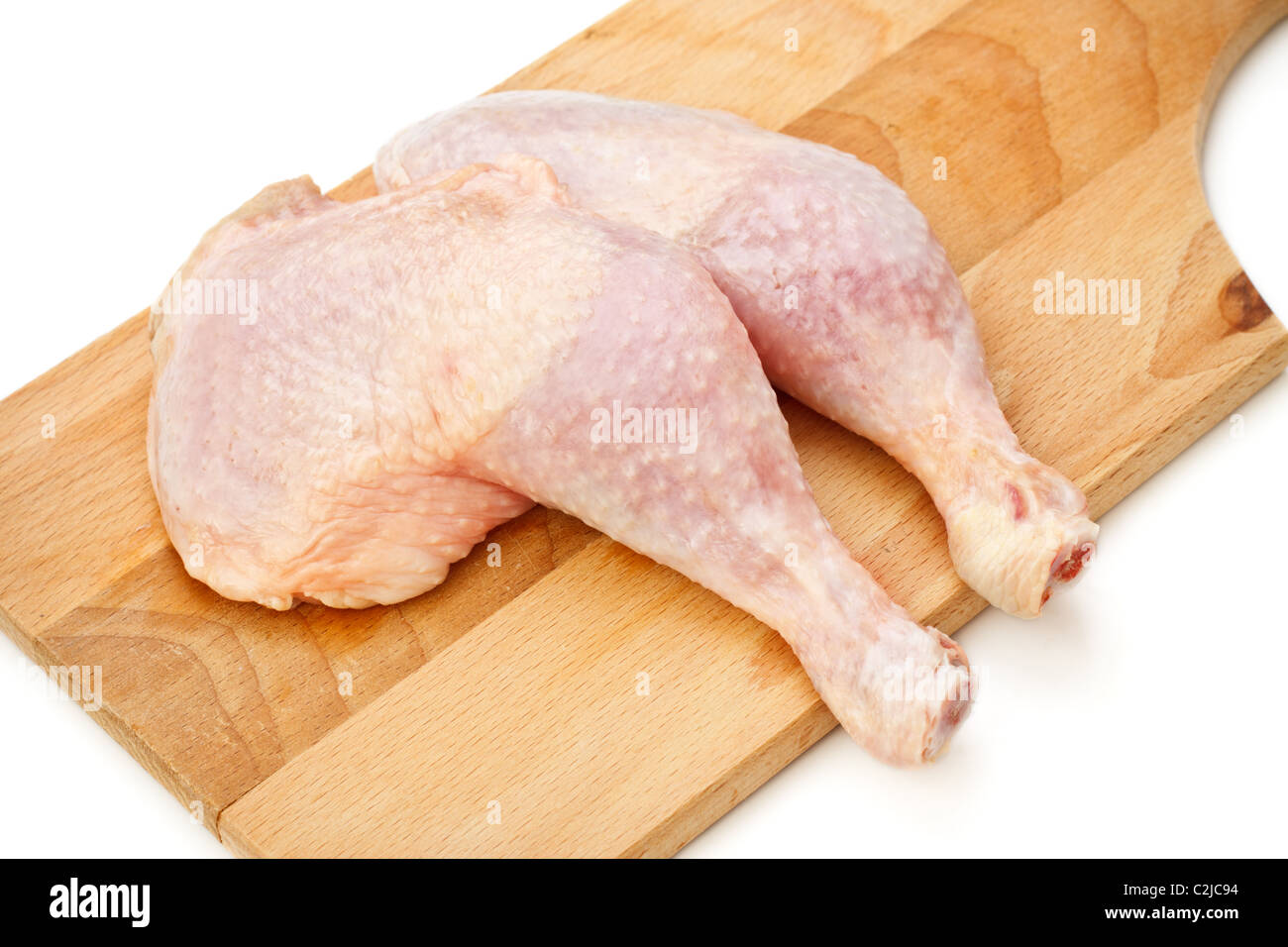 fresh chicken thighs laying on cutting board Stock Photo