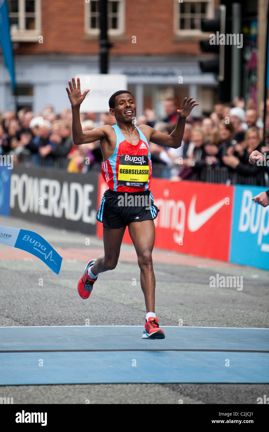 Haile Gebrselassie crosses the line after winning the Manchester 10k run in 2010. Stock Photo