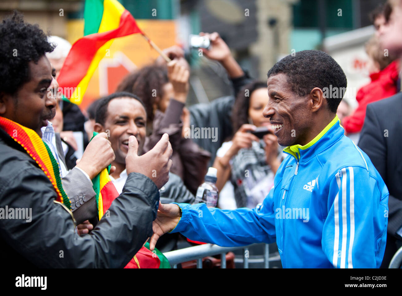 Haile Gebrselassie celebrates with fellow ethiopians after winning the manchester 10k in 2010 Stock Photo