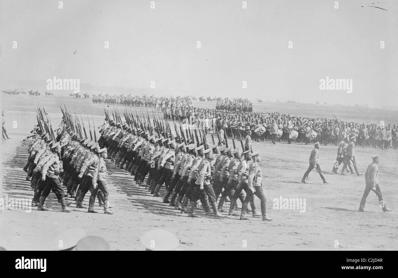 Tsarist Troops parade and pass in Review in Formation across field while a marching band plays Stock Photo
