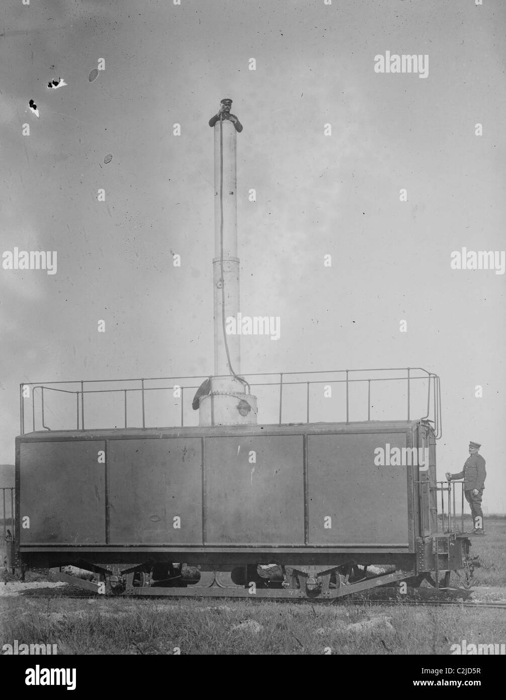 A Train Carries a man 10 stories aloft on what looks like a Chimney Stock Photo