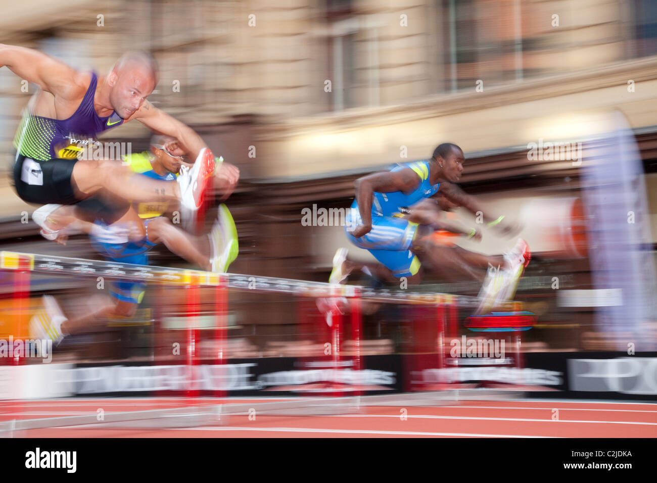 Andy Turner races Terrence Trammell and felix sanchez in the 110m hurdles at Manchester Great City Games 2010 on deansgate. Stock Photo