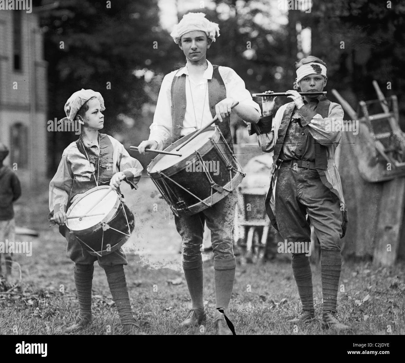 Three Boys March with Instruments on the 4th of July Celebration Stock Photo