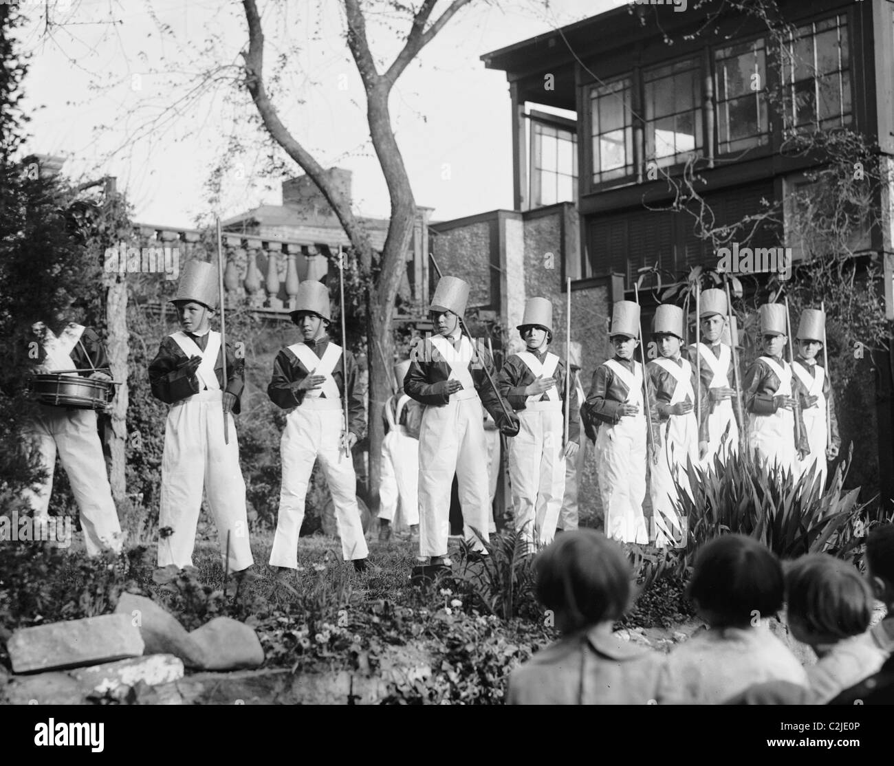 Line of Boys pose as Soldiers with inverted pails on their heads Stock Photo