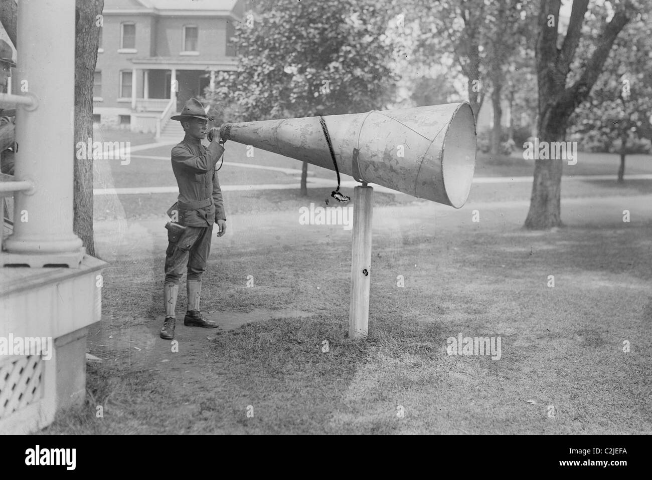 Army Bugler employs Large Megaphone to Wake Everyone Stock Photo